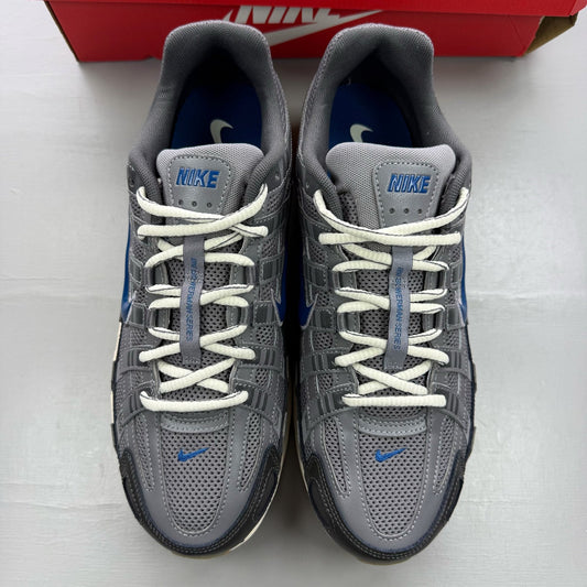 Nike grey blue trainers with pencil point design and logo detail.