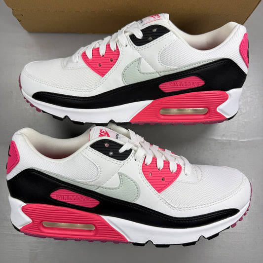 Nike Air Max 90 white trainers with aster pink and black accents, logo on tongue.