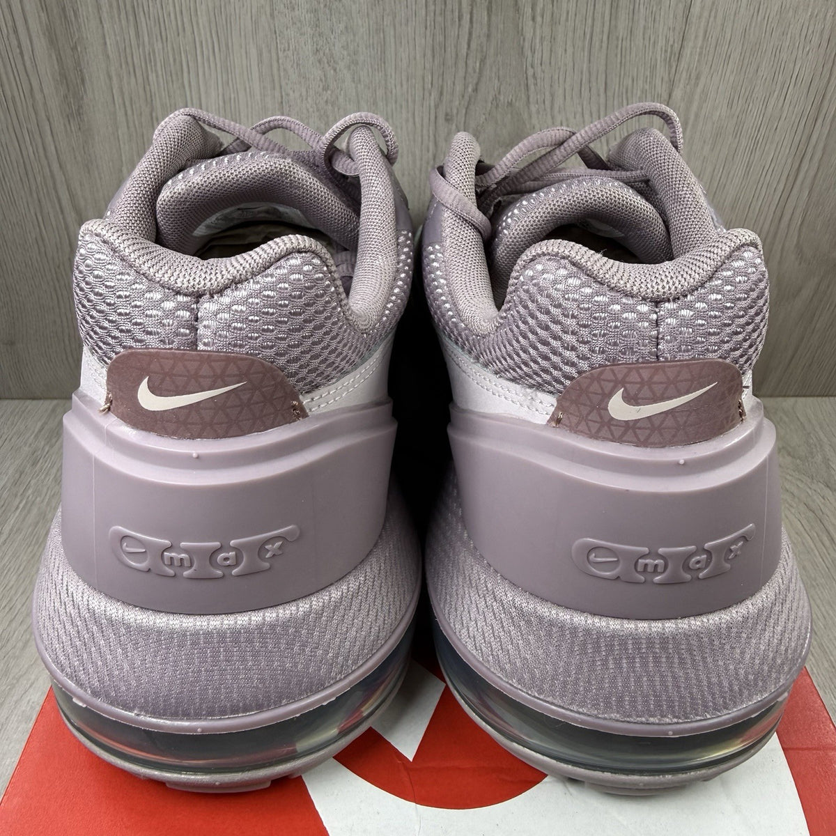 Nike Air Max Pulse purple trainers with unique design and textured material.