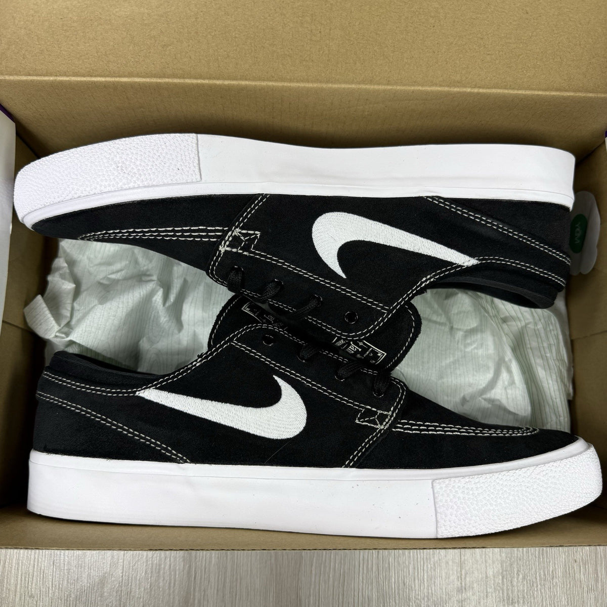 Nike black SB Zoom Stefan Janoski RM sneakers with white logo and sleek design.