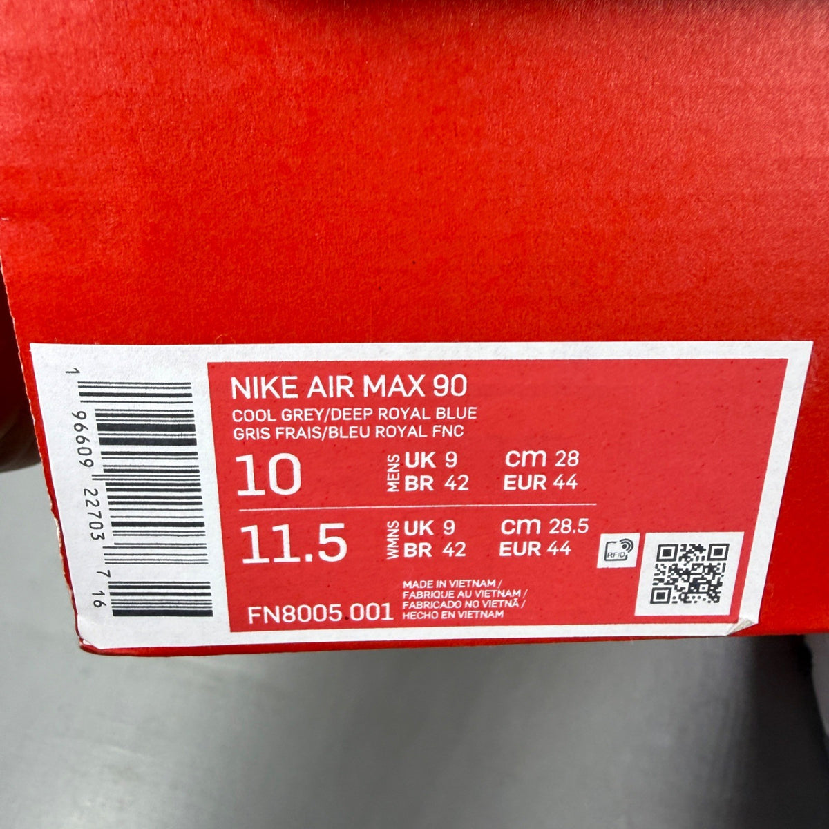 Nike athletic shoes grey with blue accents and Air Max logo detail.