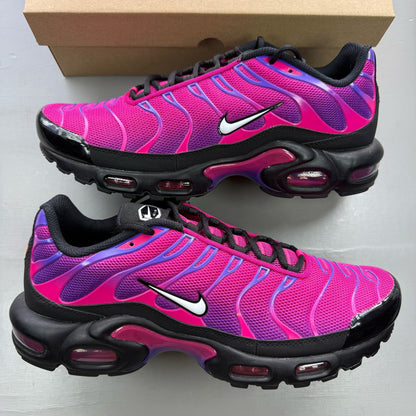 Nike Air Max Plus TN pink and purple trainers with distinctive wave pattern and logo.