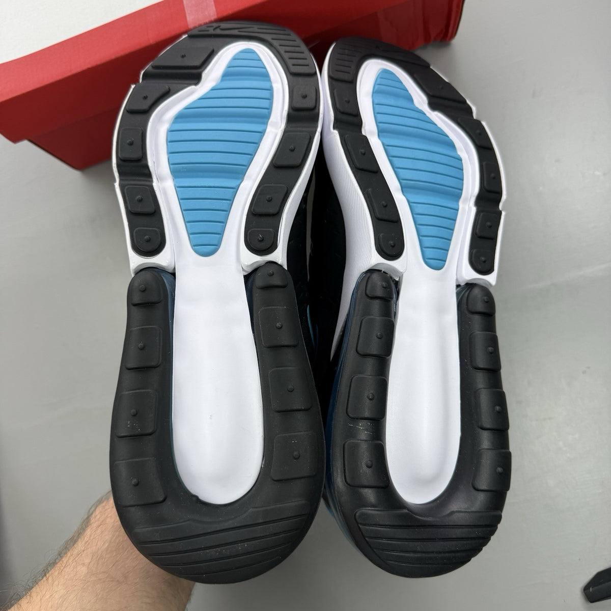 Nike Air Max 270 black trainers with light blue accents and white sole.