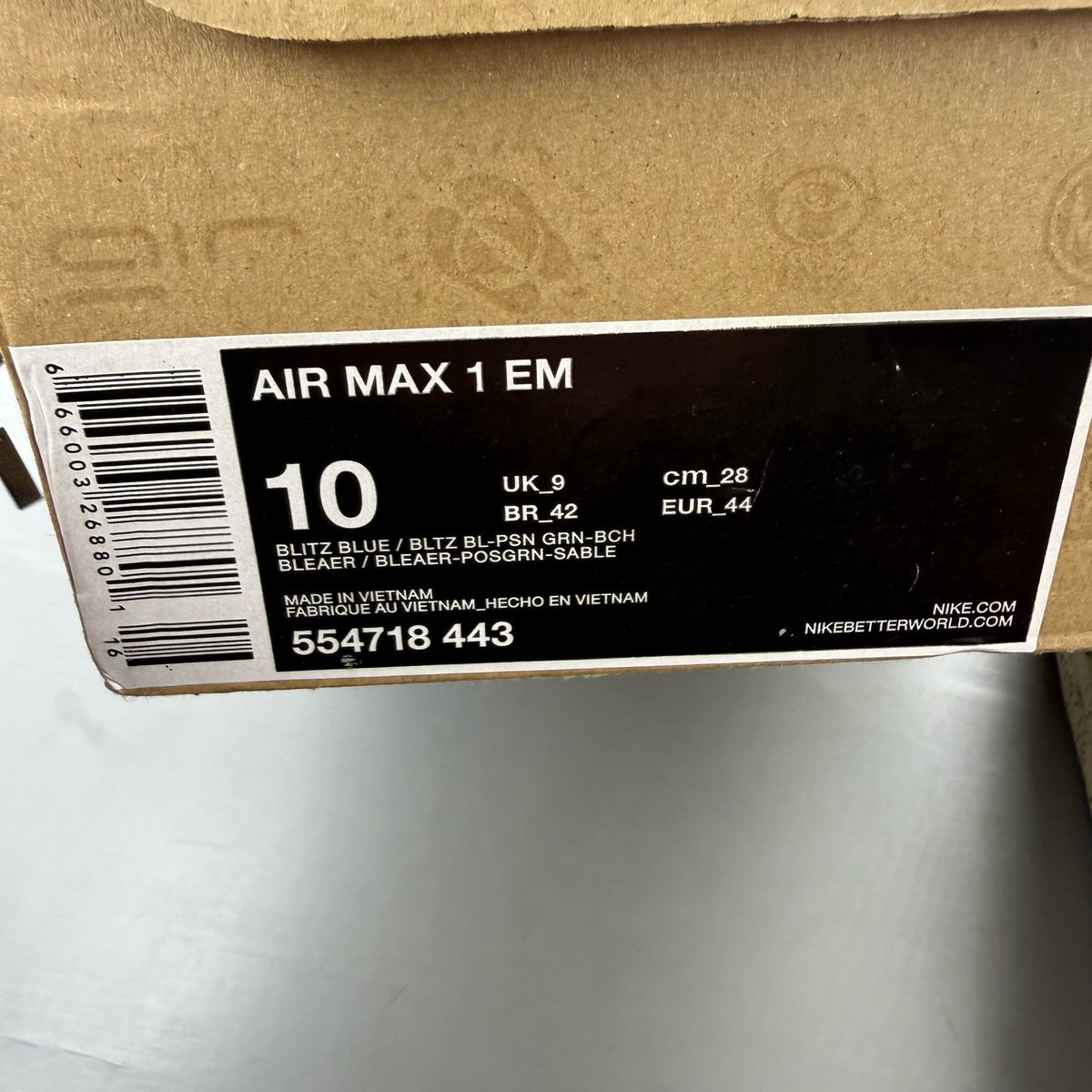 Nike Air Max 1 EM blue trainers with mesh upper and signature swoosh logo.