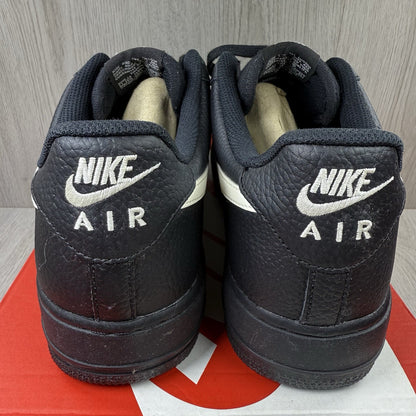 Nike Air Force 1 Low trainers black with white swoosh logo and sail accents.