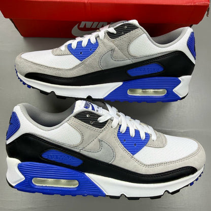 Nike Air Max 90 white trainers with hyper royal blue and grey accents.