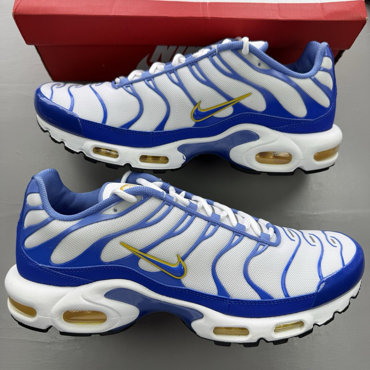 Nike Air Max Plus TN white trainers with blue and yellow accents, mesh upper.
