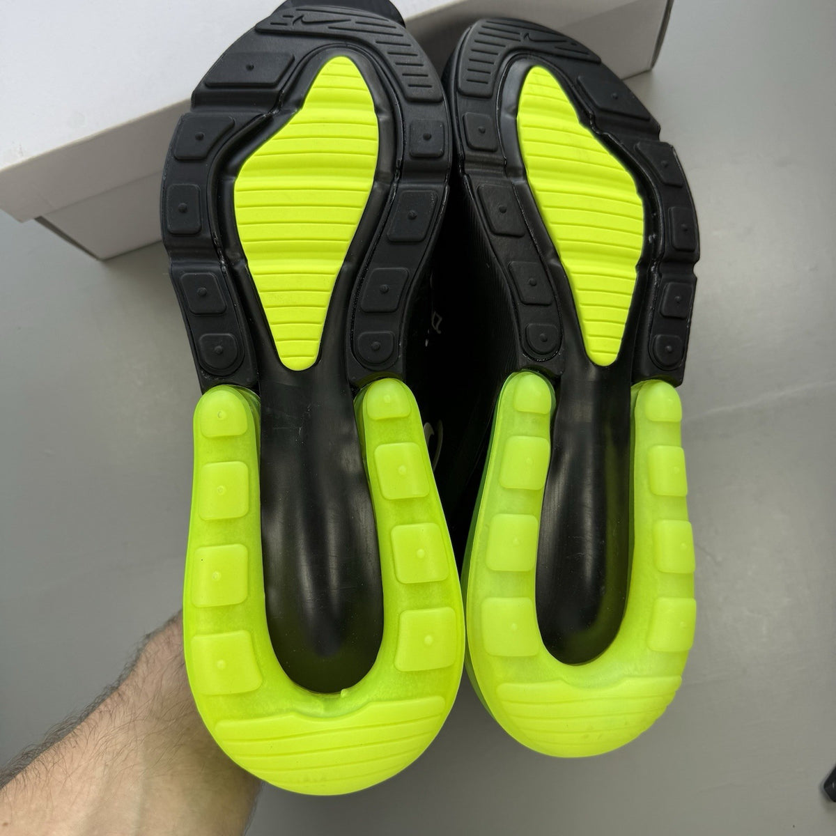 Nike Air Max 270 black trainers with neon volt accents and white sole.
