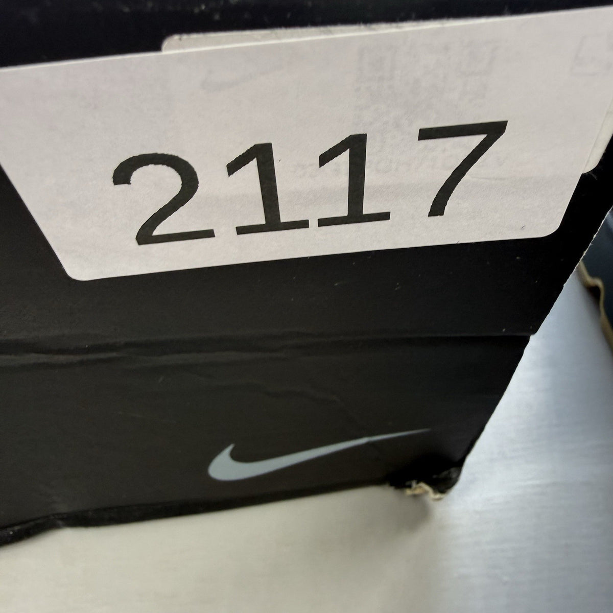 Nike Air Max 90 black trainers with reflective details and gum sole.