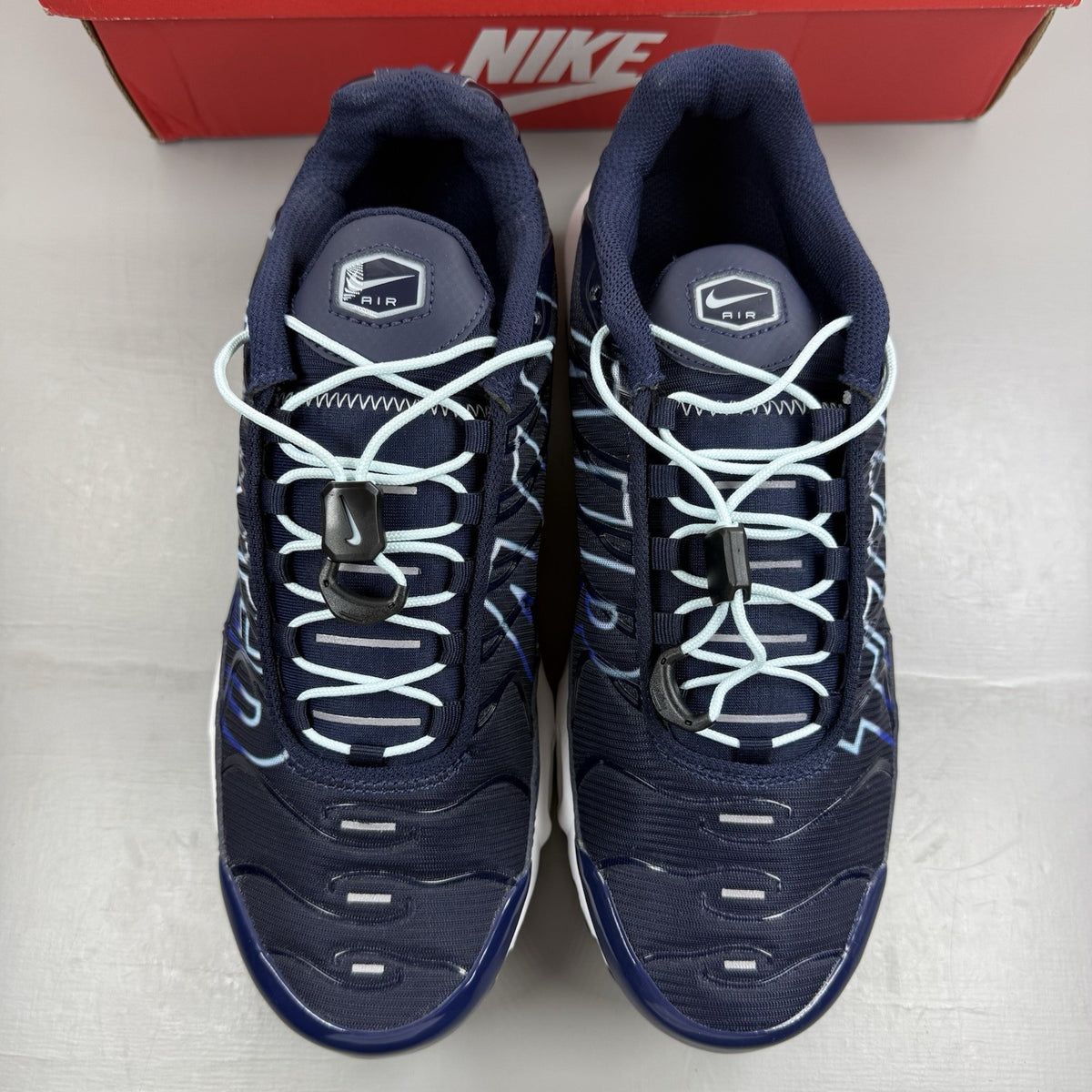 Nike Air Max Plus trainers navy blue with signature swoosh logo and mesh detailing.