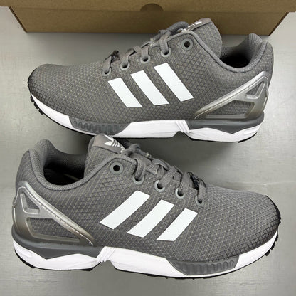 Adidas grey ZX Flux trainers with white accents and logo detail.