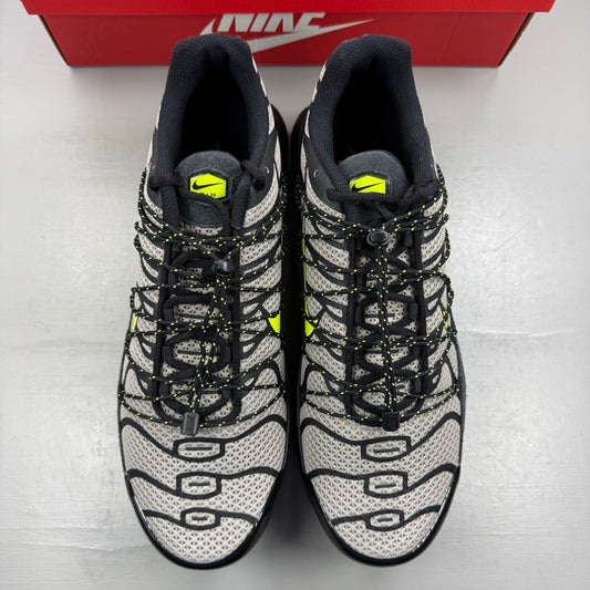 Nike deck shoes black with grey accents and volt detailing, featuring iconic logo.