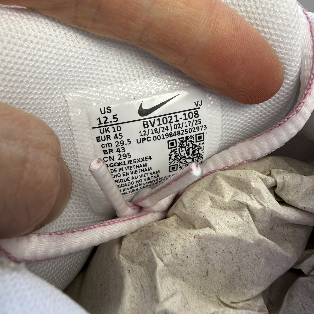 Nike P-6000 white trainers with elemental pink and silver accents, featuring logo details.