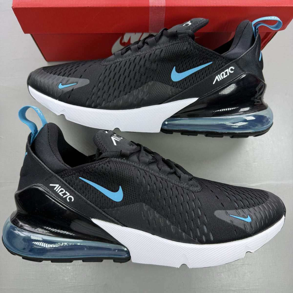 Nike Air Max 270 black trainers with light blue accents and white sole.