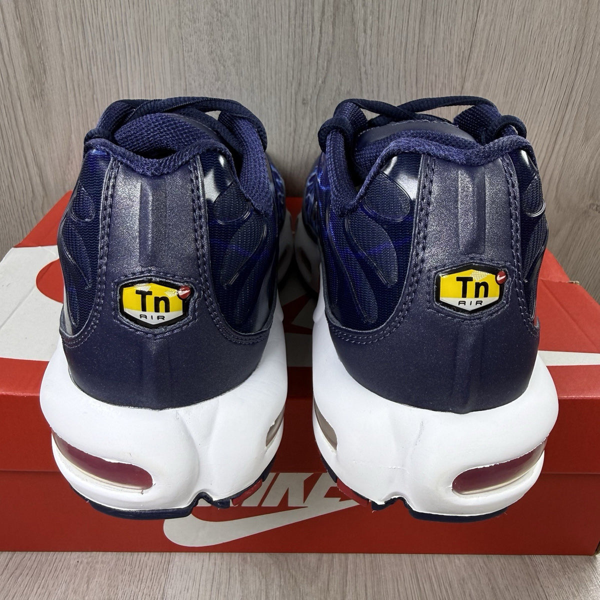 Nike Air Max Plus trainers blue with unique lightning pattern and signature logo.