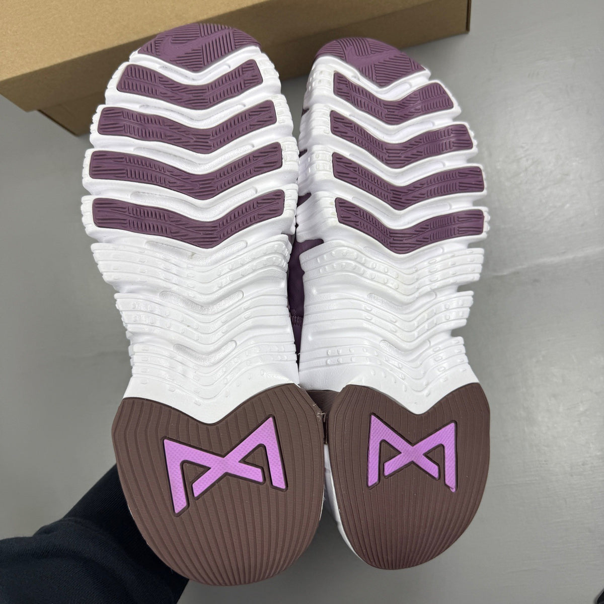 Nike Free Metcon 5 purple trainers with mesh upper and logo detail.