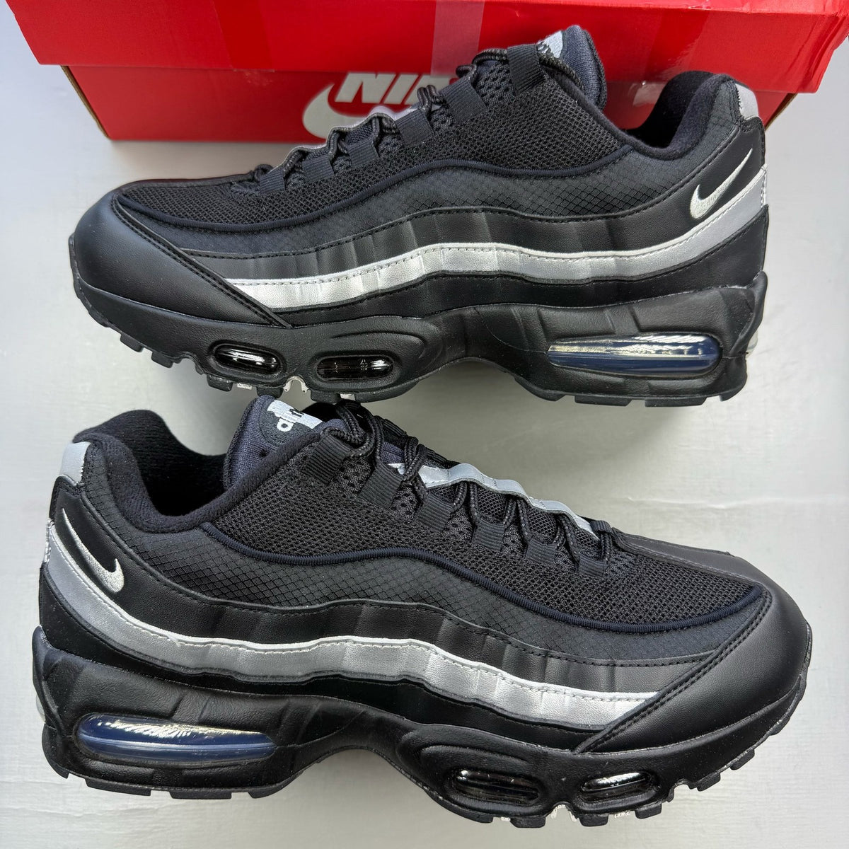 Nike Air Max 95 black trainers with silver accents and signature big bubble sole.