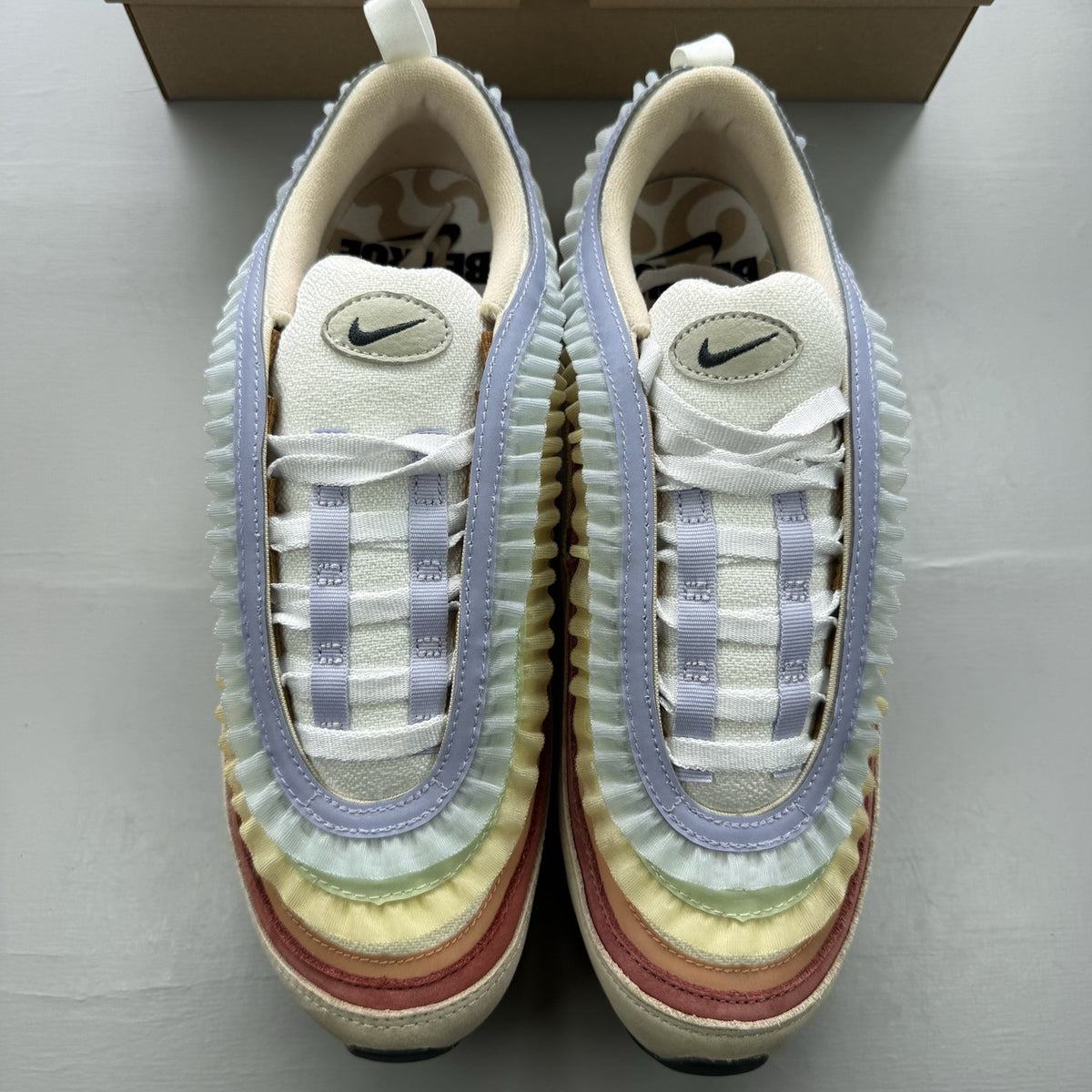 Nike Air Max 97 trainers white with pink accents and beige detailing, authentic design.
