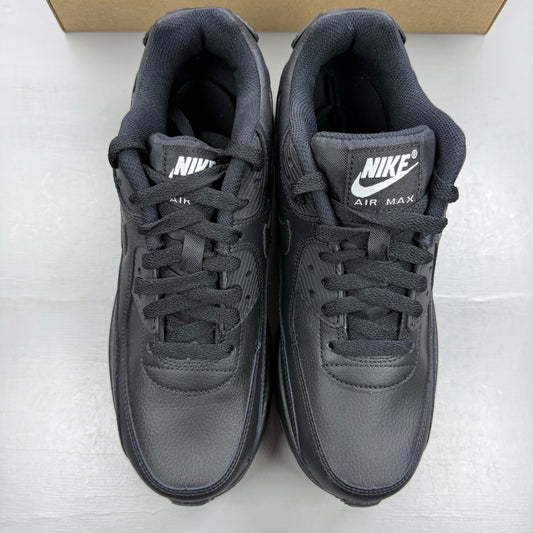 Nike Air Max 90 black leather trainers with iconic swoosh logo and textured design.
