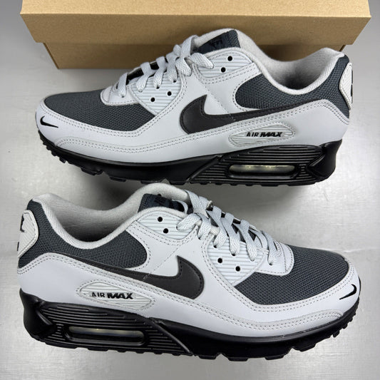 Nike trainers light smoke grey with black accents and iconic swoosh logo.