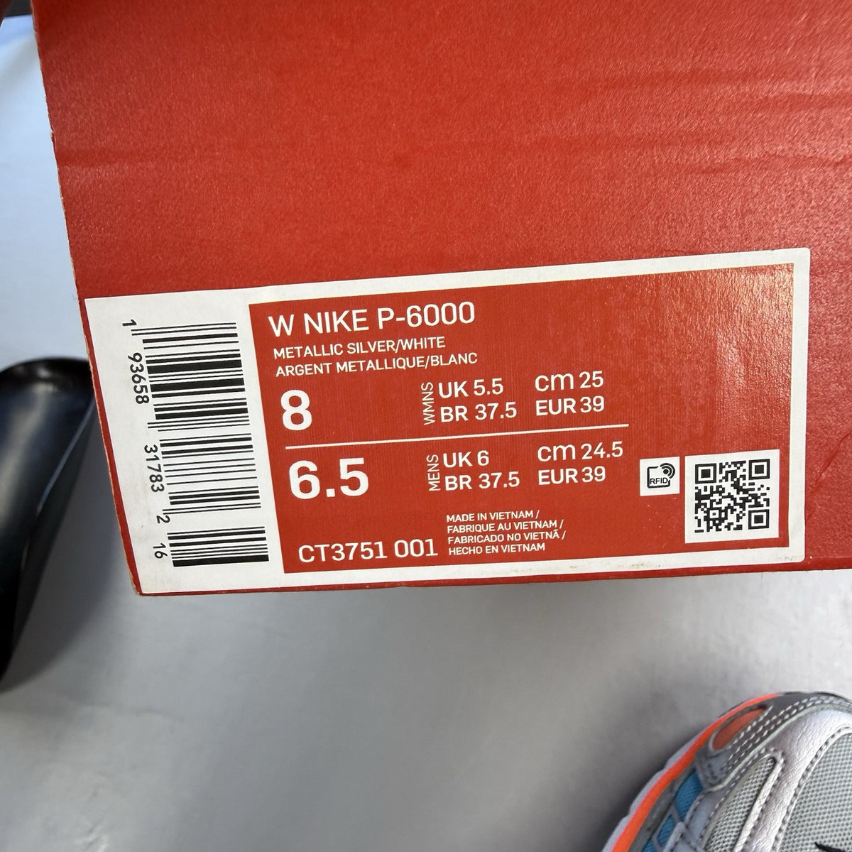 Nike P-6000 grey trainers with metallic accents and crimson blue fury details.