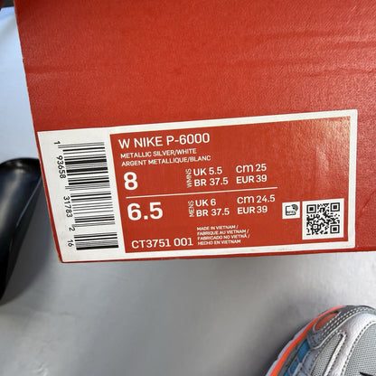 Nike P-6000 grey trainers with metallic accents and crimson blue fury details.