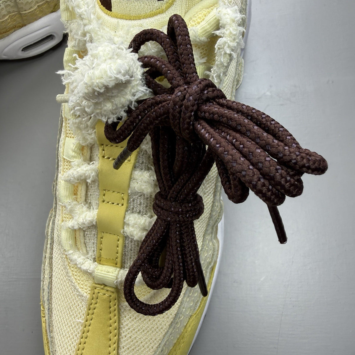 Nike Air Max 95 trainers yellow with textured upper and signature swoosh logo.