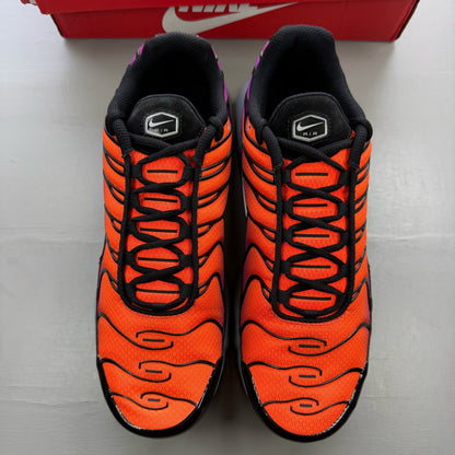 Nike Air Max Plus TN orange trainers with distinctive wave pattern and logo.