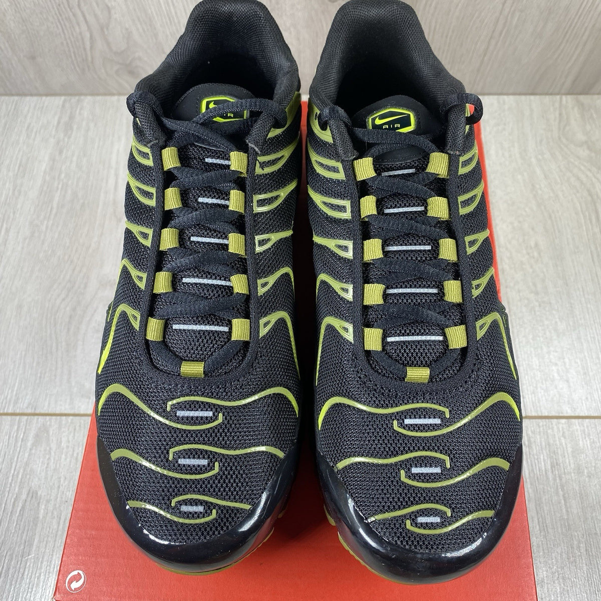 Nike Air Max Plus TN trainers black with cyber accents and mesh upper detailing.