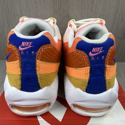 Nike Air Max 95 trainers white with campfire orange accents and signature logo details.