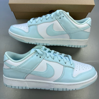 Nike Dunk Low trainers glacier blue and white with signature swoosh logo.