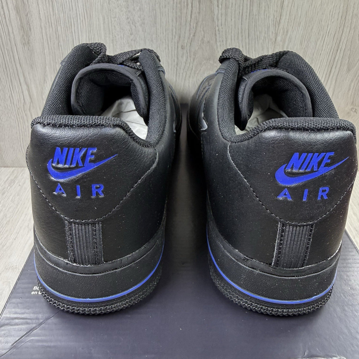 Nike black Air Force 1 Low trainers with jewel swoosh logo and grey accents.