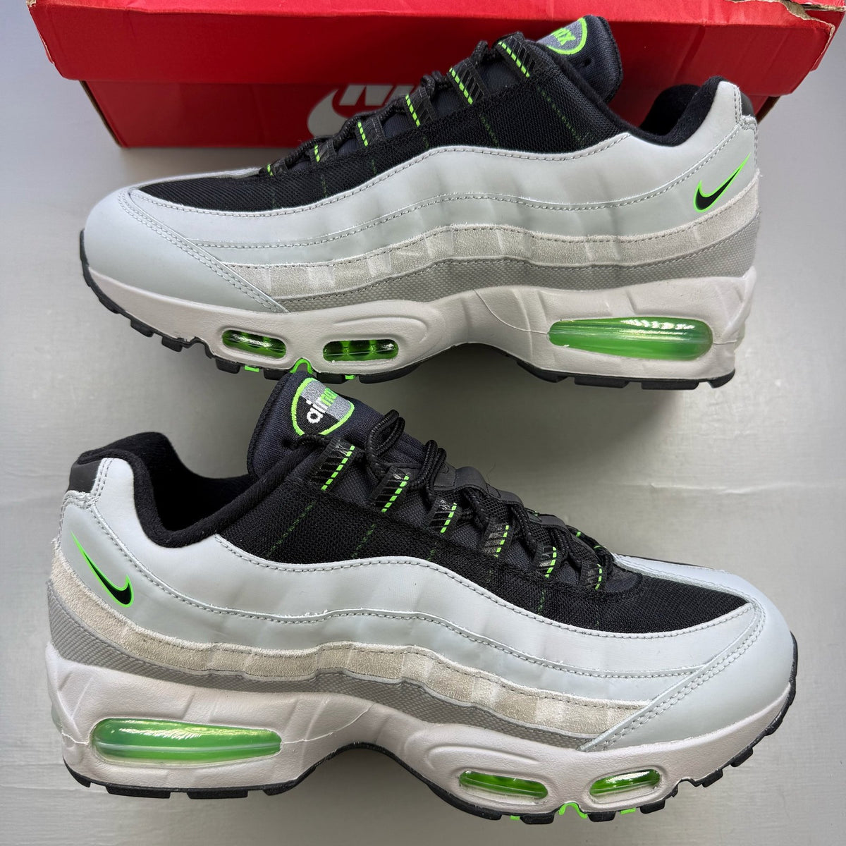 Nike Air Max 95 grey sneaker with big bubble sole and racing pack details.