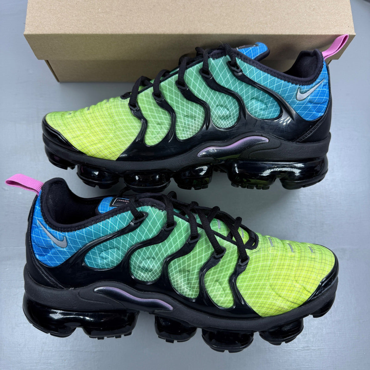 Nike athletic shoes Aurora Green with black accents and signature logo details.