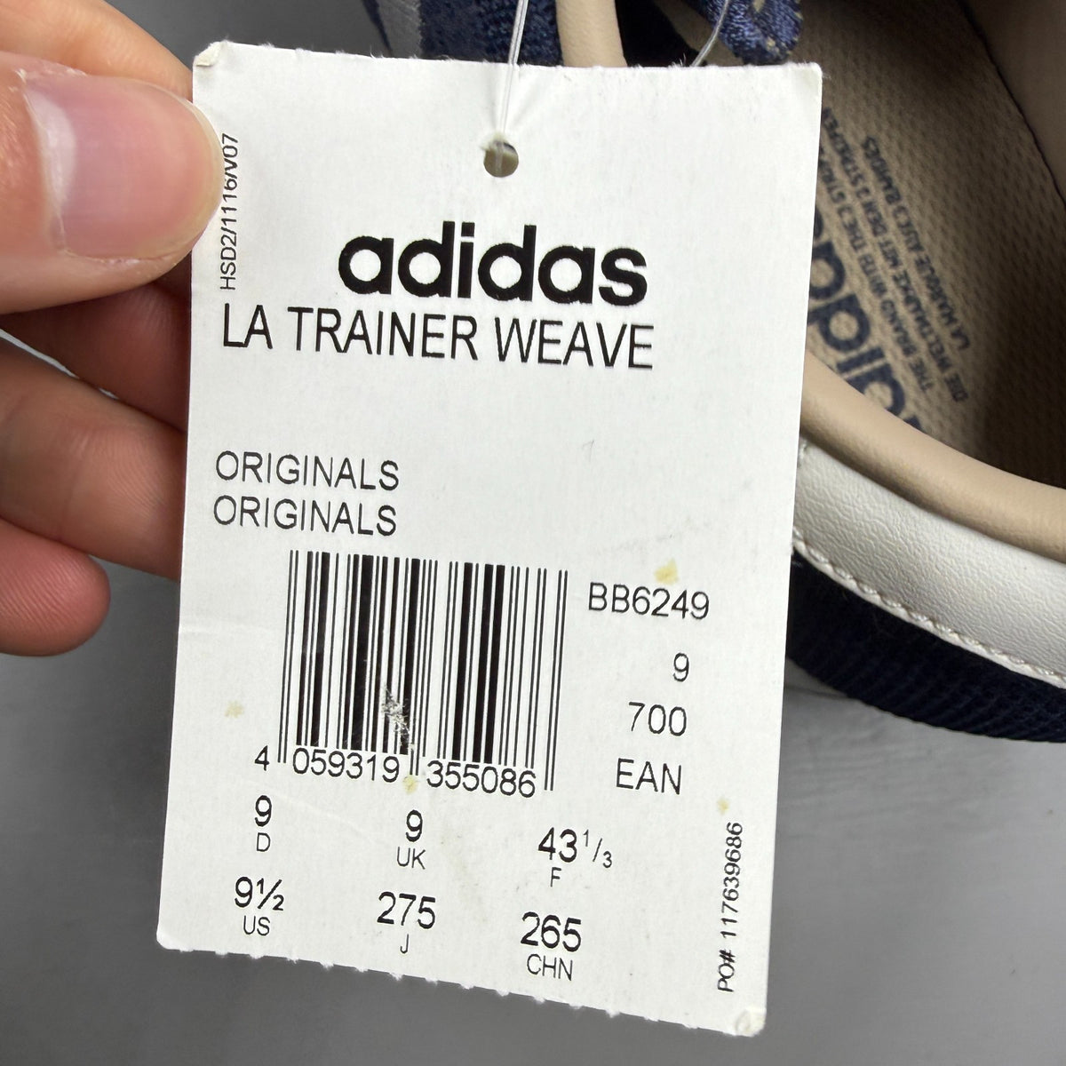Adidas blue athletic shoes with white accents and textured weave design.