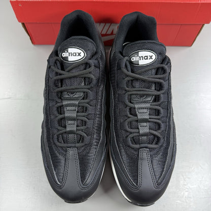 Nike Air Max 95 Essential black trainers with white accents and signature logo details.