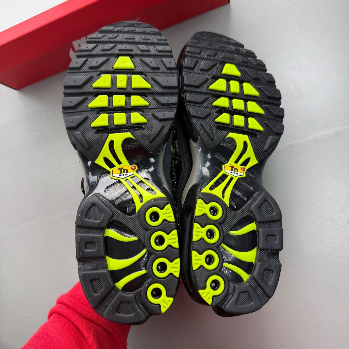 Nike Air Max Plus TN black grey volt with signature logo and sleek design.