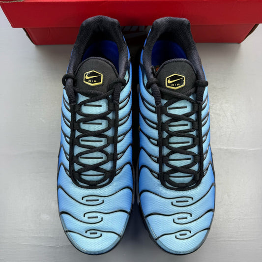 Nike Air Max Plus TN blue trainers with black accents and signature swoosh logo.