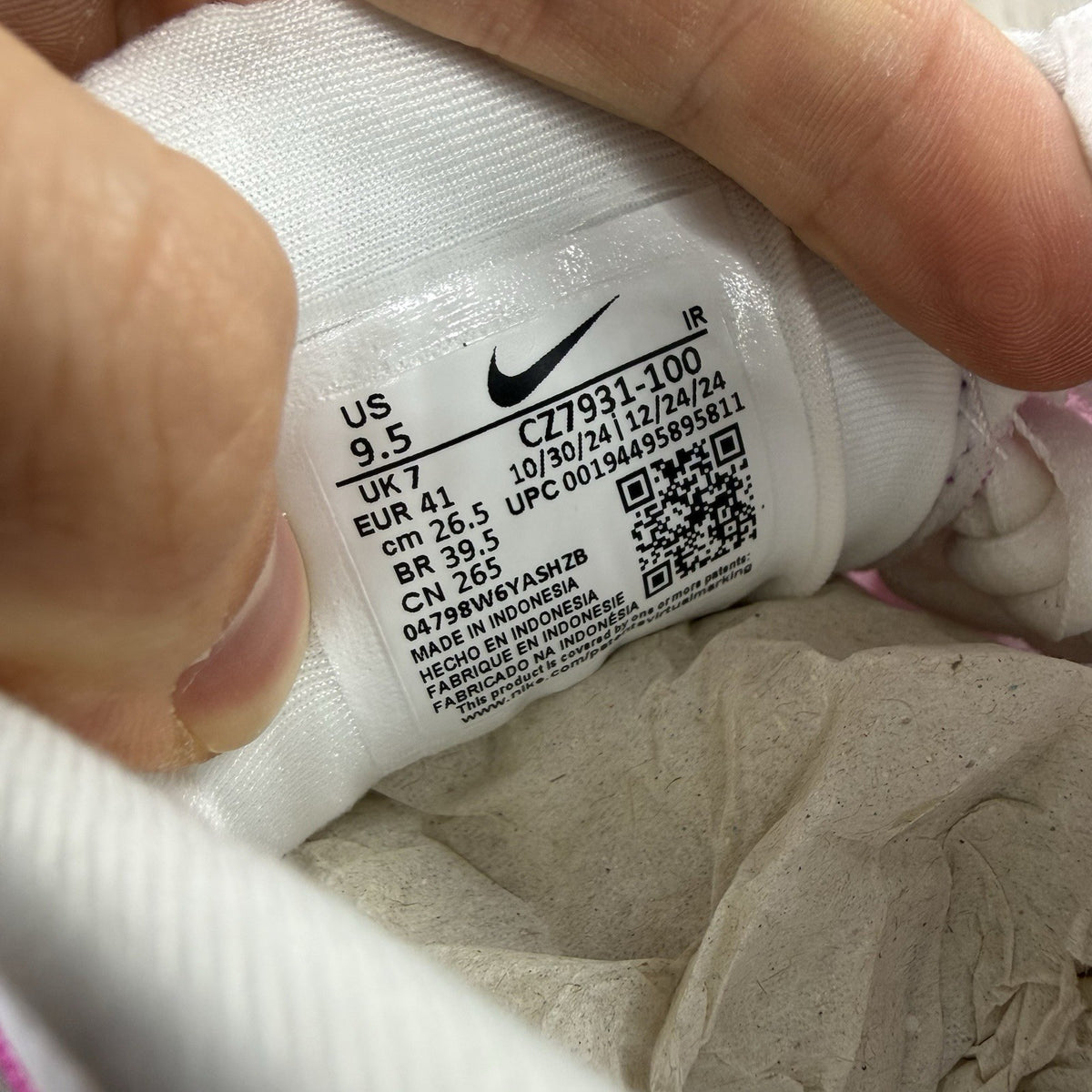 Nike Air Max Plus TN white trainers with pink fade and distinctive wavy design.