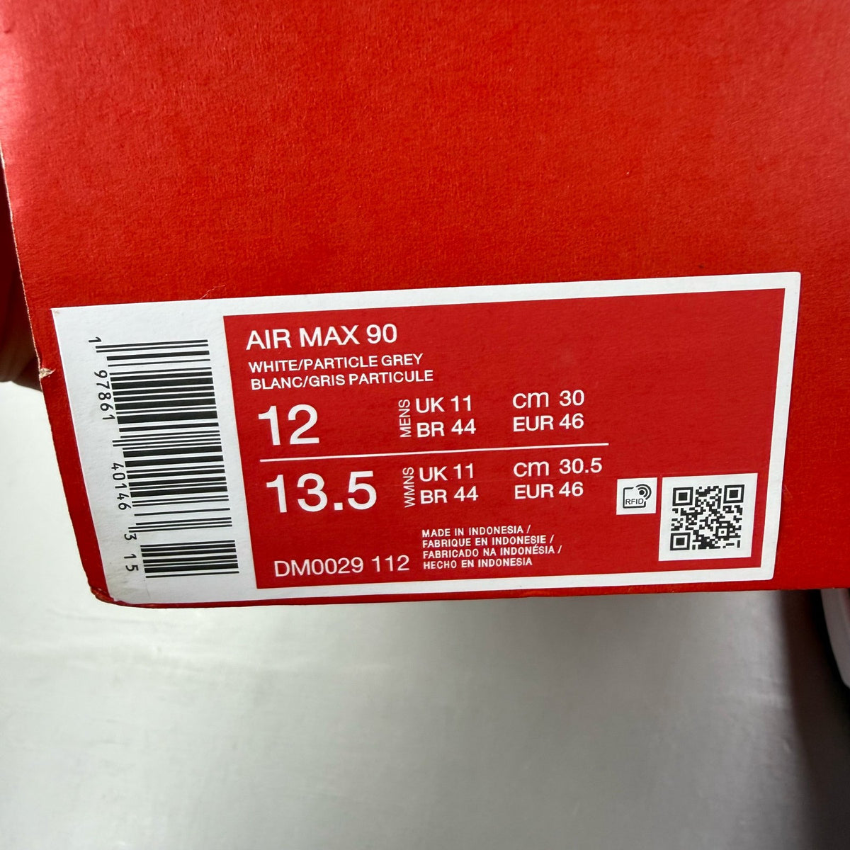 Nike Air Max 90 trainers white grey blue with signature swoosh logo and mesh details.