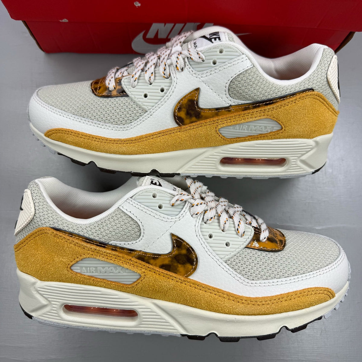 Nike beige trainers leopard tortoise shell pattern with logo detail.