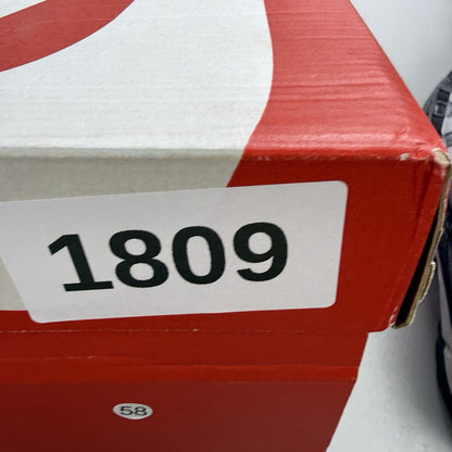 Nike black trainers with grey accents and reflective detailing, featuring a classic logo.