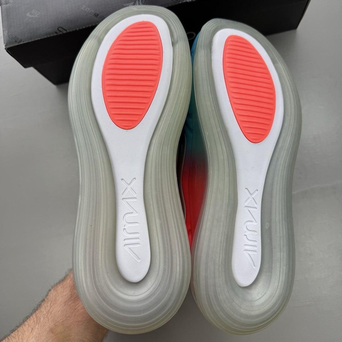 Nike Air Max 720 trainers blue with pink and lava glow accents, mesh upper.