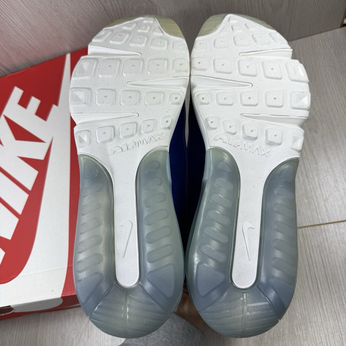Nike Air Max 2090 trainers white with red and blue accents, featuring logo details.