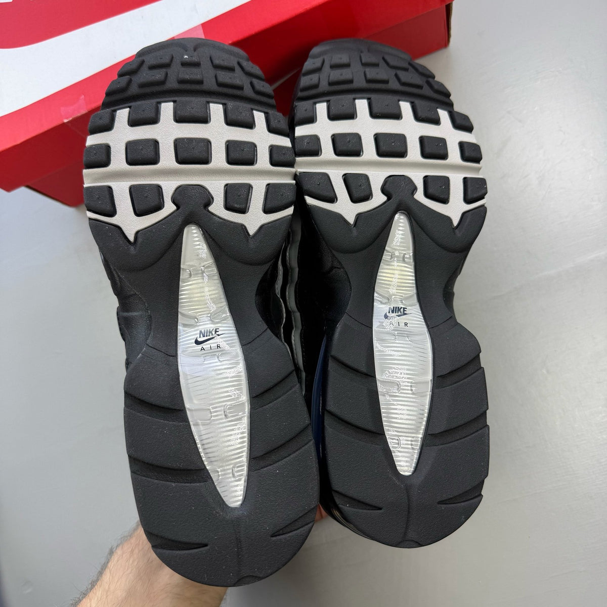 Nike Air Max 95 black trainers with silver accents and signature big bubble sole.