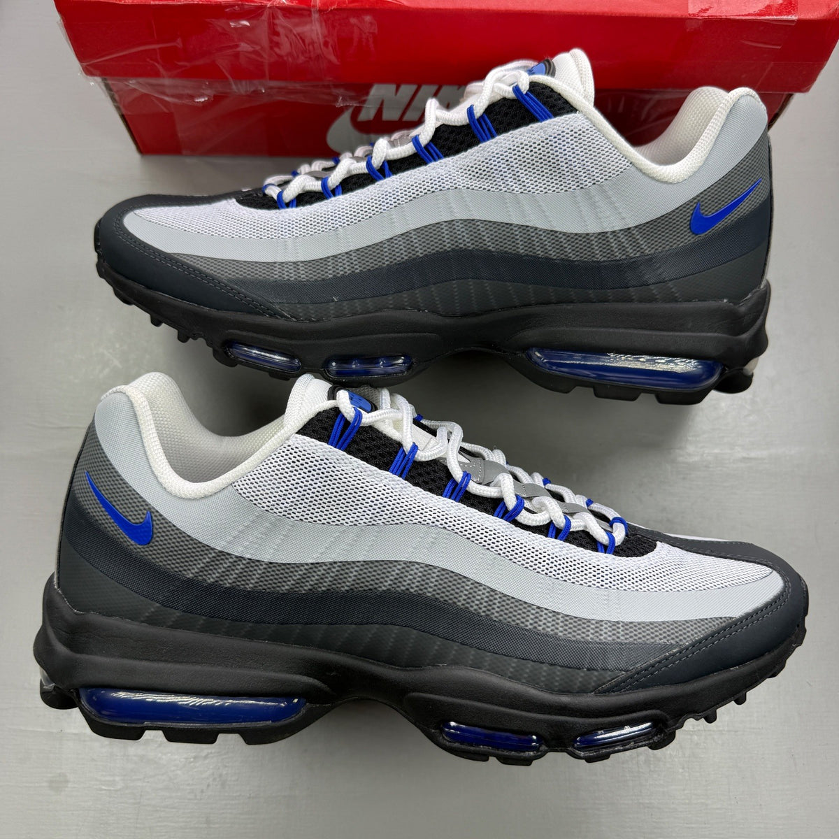 Nike Air Max 95 Ultra grey with racer blue accents and textured mesh upper.