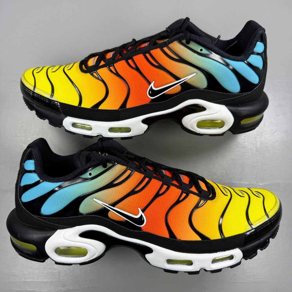 Nike running shoes blue with safety orange accents and signature logo.