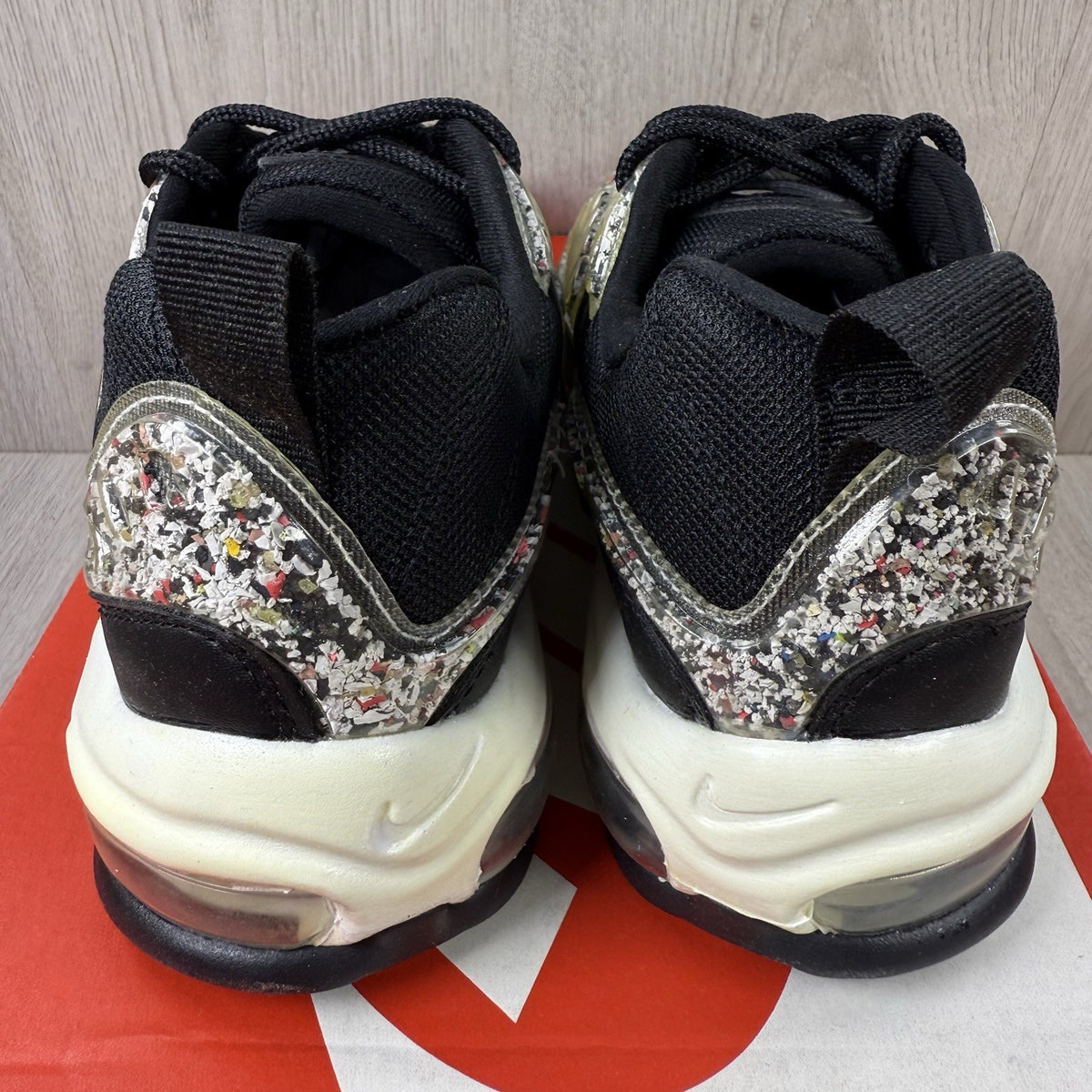 Nike Air Max 98 trainers black with white accents and signature logo detail.
