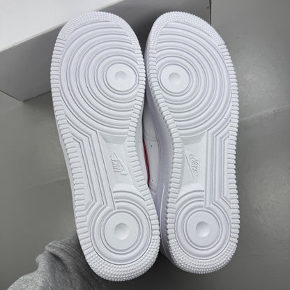 Nike deck shoes white leather with red accents and logo detail.