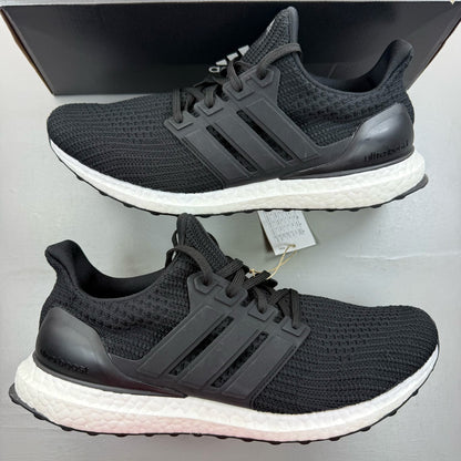 Adidas black Ultra Boost trainers with white accents and signature three-stripe logo.